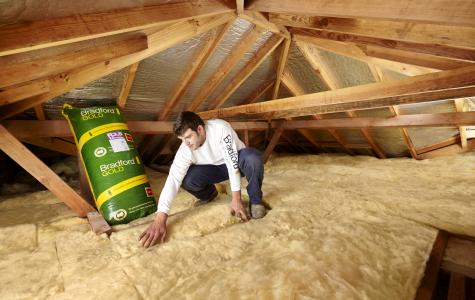 Installation of rockwool insulation material in a ceiling.